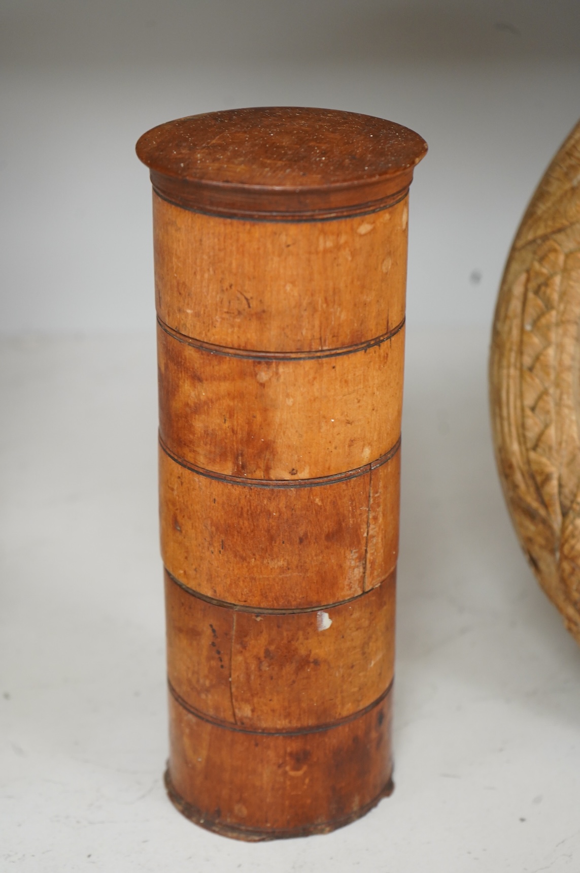 A Victorian treen spice tower and a carved bread board, 30cm in diameter